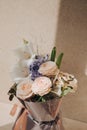 A bouquet of flowers, roses, dahlias, gladioli in a beautiful pink package on a light stone background Royalty Free Stock Photo