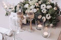 Bouquet of flowers from roses with glasses and candles on the wedding table Royalty Free Stock Photo