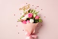 Bouquet of flowers with sign Happy Mother\'s Day on pastel pink background