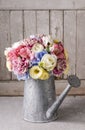 Bouquet of flowers in silver watering can Royalty Free Stock Photo
