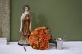 Bouquet of flowers and statue of Santa Terezinha