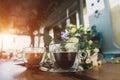 A bouquet of flowers and two cups of coffee on the table