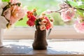 Bouquet of flowers in a vase in front of window Royalty Free Stock Photo