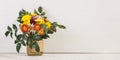 Bouquet of flowers in a vase on a white table, copy space banner