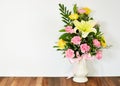 Bouquet of flowers in vase on wooden table Royalty Free Stock Photo