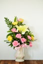 Bouquet of flowers in vase on wooden table Royalty Free Stock Photo