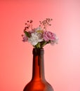 bouquet of flowers white pink yellow from the neck of the bottle. womens day, floral wine aromas. red background