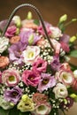 Bouquet of flowers in a wooden box. multi-colored roses and wild white flowers
