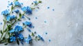 A bouquet of forget-me-not flowers lies on the left on a white minimalistic background
