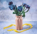 A bouquet of fresh blue tulip flowers in a pink vase. Still life with spring flowers Royalty Free Stock Photo