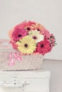 Bouquet Of Fresh Bright Multi-colored Gerbera Flowers In A Wicker Basket On An Old White Suitcase, Still Life, Vintage Background