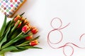A bouquet of fresh orange tulips and a gift box on a white background. women day Royalty Free Stock Photo