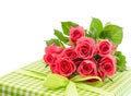 Bouquet of fresh pink roses with gift isolated on white Royalty Free Stock Photo