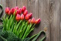 Bouquet of fresh pink tulips on a wooden background, top view. Royalty Free Stock Photo