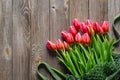 Bouquet of fresh pink tulips on a wooden background, top view. Royalty Free Stock Photo