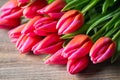 Bouquet of fresh pink tulips on a wooden background, close-up. Royalty Free Stock Photo