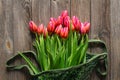 Bouquet of fresh pink tulips on a wooden background, top view. Royalty Free Stock Photo