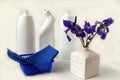A bouquet of fresh Siberian irises with napkins on the background of detergents in white bottles, side view-the concept of Royalty Free Stock Photo