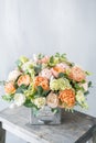 Bouquet of fresh spring flowers on gray wall background. Floral arrangement in vintage metal vase. flower shop, florist Royalty Free Stock Photo