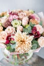 Bouquet of fresh spring flowers on gray wall background. Floral bunch in glass vase. flower shop, florist work Royalty Free Stock Photo