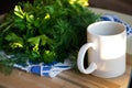 A bouquet of green parsley leaves with white mug.