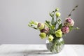 Bouquet of green and pink terry lisianthus and eucalyptus branches in a transparent round vase on white background. Bride bouquet