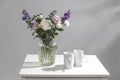 Bouquet of hackelia velutina, purple and white roses, small tea roses, matthiola incana and blue iris in glass vase Royalty Free Stock Photo