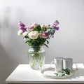 Bouquet of hackelia velutina, purple and white roses, small tea roses, matthiola incana and blue iris in glass vase is on the Royalty Free Stock Photo