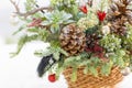 Bouquet has Christmas tree branches and artificial flowers. Royalty Free Stock Photo