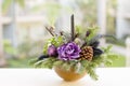 Bouquet has Christmas tree branches and artificial flowers. Royalty Free Stock Photo