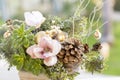 Bouquet has Christmas tree branches and artificial flowers. Royalty Free Stock Photo