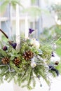 Bouquet has Christmas tree branches and artificial flowers. Royalty Free Stock Photo