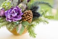 Bouquet has Christmas tree branches and artificial flowers. Royalty Free Stock Photo