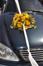 Bouquet on the hood of the wedding car Royalty Free Stock Photo