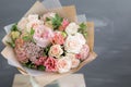 Bouquet in kraft paper. A simple bouquet of flowers and greens Royalty Free Stock Photo