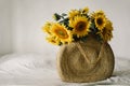 A bouquet of large sunflowers in wicker bag