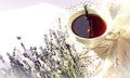 Bouquet of lavender branches with a Cup of tea on an openwork white napkin in the sun with the shadow of objects, side view