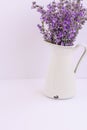 Bouquet of lavender flowers in white pot isolated on purple background