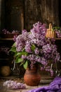 Bouquet of lilac flowers in a ceramic pot on old table Royalty Free Stock Photo