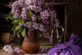 Bouquet of lilac flowers in a ceramic pot on old table Royalty Free Stock Photo