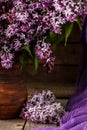 Bouquet of lilac flowers in a ceramic pot on old table. Royalty Free Stock Photo