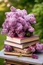 bouquet of lilacs and old books, on a table in the garden in the shade of trees Royalty Free Stock Photo