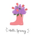 Bouquet of lilacs and tulips in pink rubber boot. Beautiful spring flowers. Hello Spring concept