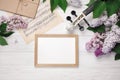A bouquet of lilacs with violin, chalk board and music sheet on a white wooden table. Top wiev with space for your text Royalty Free Stock Photo