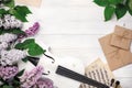 A bouquet of lilacs with violin, letter and music sheet on a white wooden table. Top wiev with space for your text Royalty Free Stock Photo