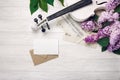 A bouquet of lilacs with violin, letter and music sheet on a white wooden table. Top wiev with space for your text Royalty Free Stock Photo