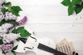 A bouquet of lilacs with violin and music sheet on a white wooden table. Top wiev with space for your text Royalty Free Stock Photo
