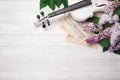 A bouquet of lilacs with violin and music sheet on a white wooden table. Top wiev with space for your text Royalty Free Stock Photo