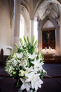 Bouquet of lilies and snapdragons in church