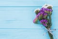 Bouquet of limonium statice flowers on wood and copyspace.